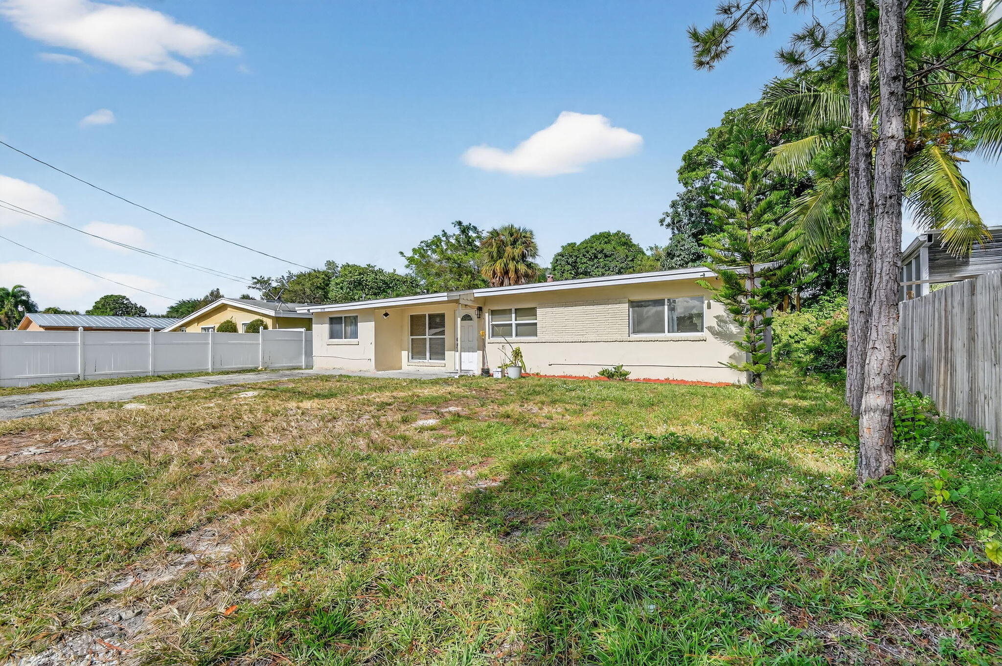 4559 Cole Street West Palm Beach, FL 33417 - Photo 5 of 72 a view of a house with backyard and garden