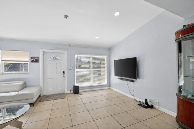 a living room with furniture and kitchen view