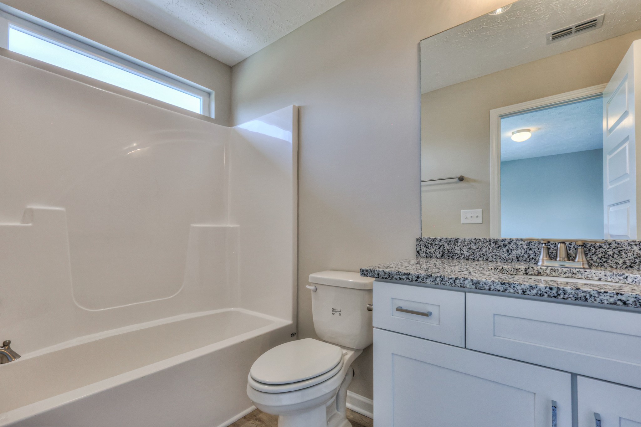 1234 North Fork Branch Road Normandy, TN 37360 - Photo 33 of 38 a bathroom with a granite countertop toilet a sink and bathtub