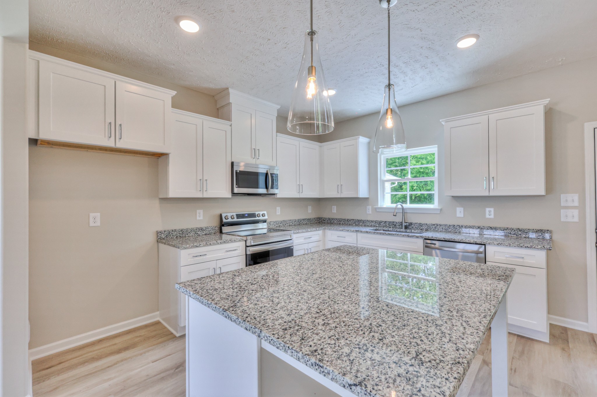 1234 North Fork Branch Road Normandy, TN 37360 - Photo 10 of 38 a kitchen with kitchen island granite countertop a sink a counter space appliances and cabinets