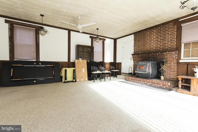 402 Whitaker Mill Road Fallston, MD 21047 - Photo 23 of 29 a living room with furniture fireplace and a flat screen tv
