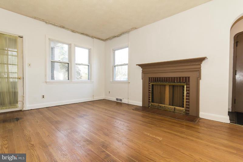 402 Whitaker Mill Road Fallston, MD 21047 - Photo 9 of 29 an empty room with wooden floor cabinet and windows