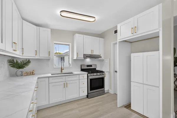 a kitchen with cabinets stainless steel appliances and a counter space