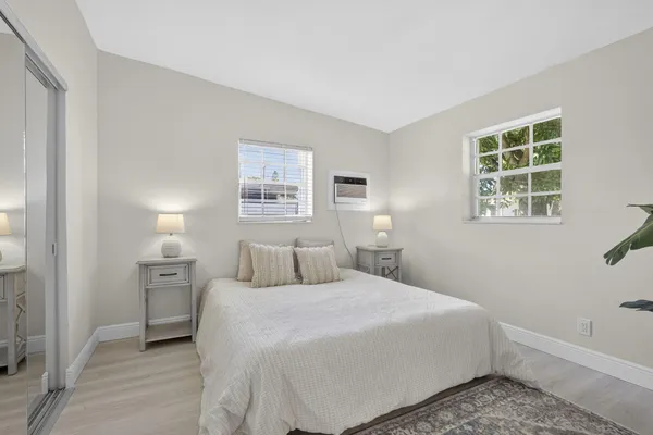 a bedroom with a bed and a night stand