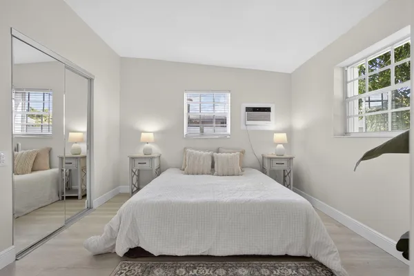 a bedroom with a bed and glass window