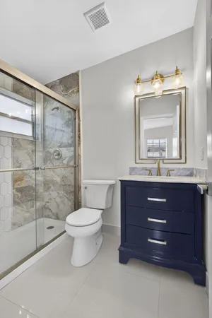 a bathroom with a toilet a sink and mirror