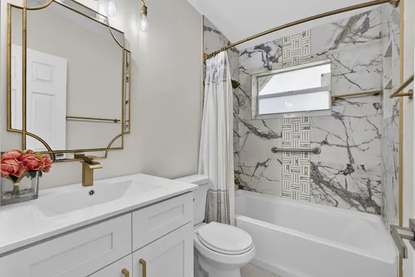 a bathroom with a sink a toilet and a bathtub