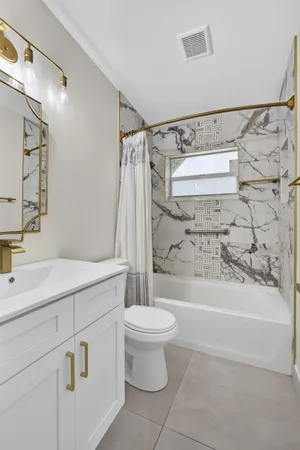 a bathroom with a sink a toilet and a bathtub