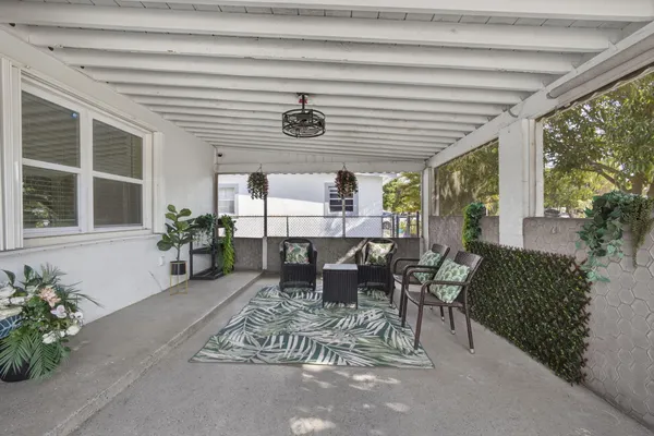 a dining room with furniture and a potted plant