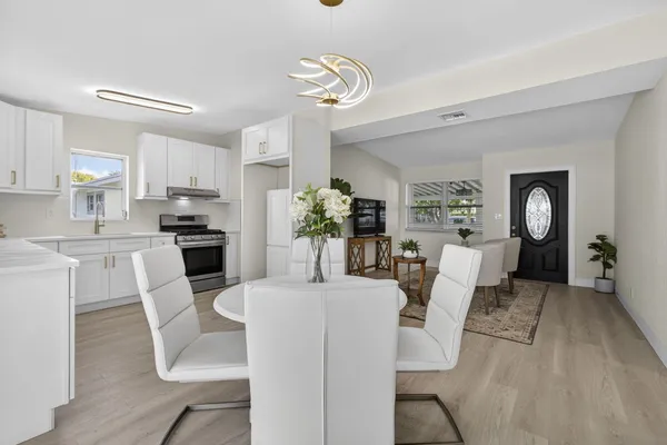 a view of a dining room with furniture and wooden floor