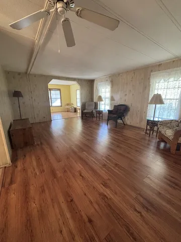 a view of a livingroom with furniture wooden floor and a window