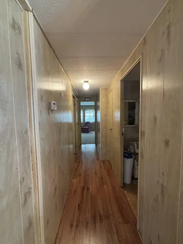 a view of hallway with wooden floor