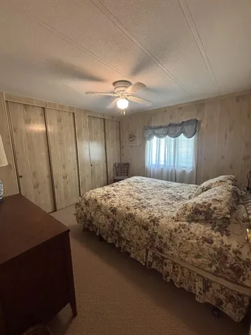 a spacious bedroom with a bed and a chandelier