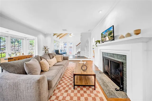 a living room with furniture a fireplace with wooden floor