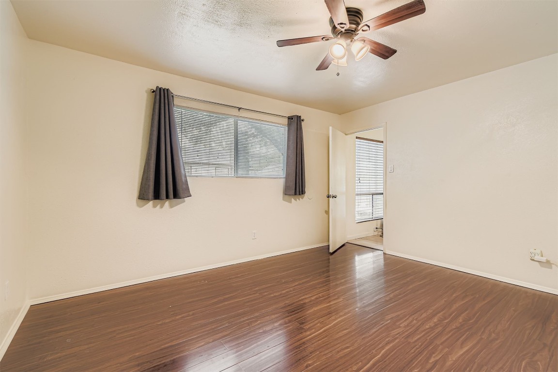 3104 Dominic Drive Austin, TX 78745 - Photo 14 of 28 Unfurnished room featuring dark wood-style floors and a ceiling fan