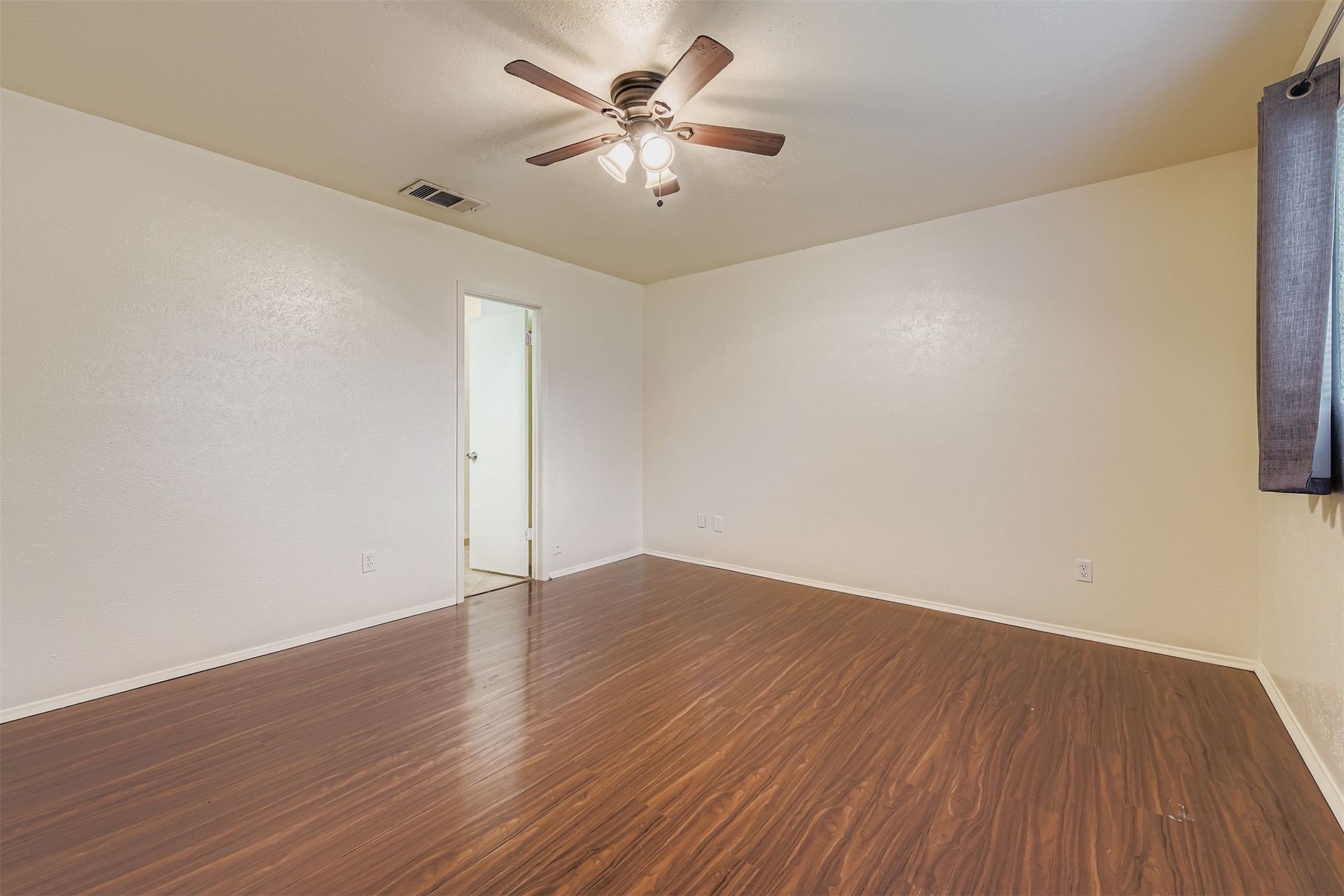 3104 Dominic Drive Austin, TX 78745 - Photo 15 of 28 Empty room with dark wood-style flooring and ceiling fan