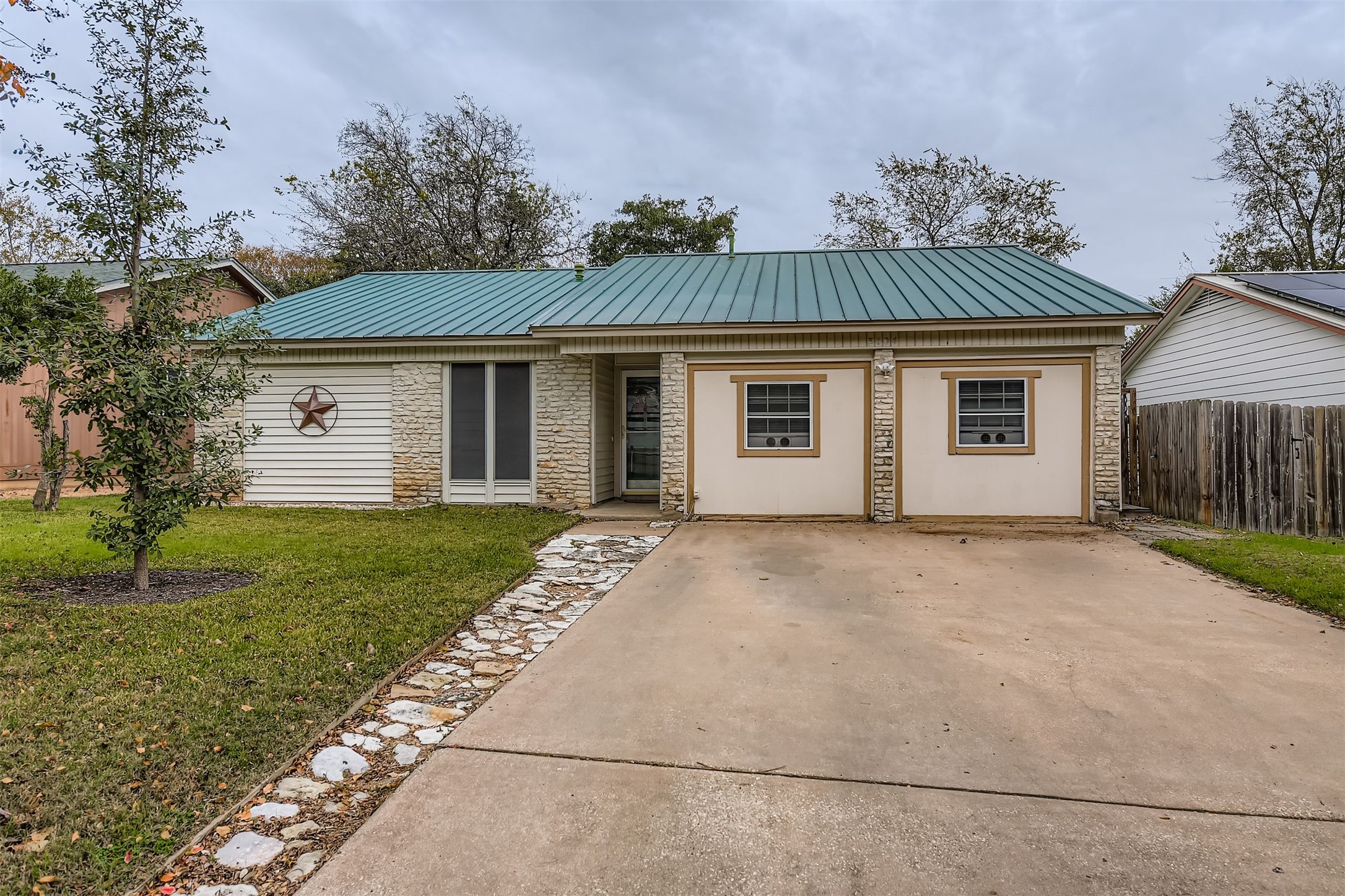 3104 Dominic Drive Austin, TX 78745 - Photo 2 of 28 Ranch-style house featuring a metal roof, stone siding, and driveway