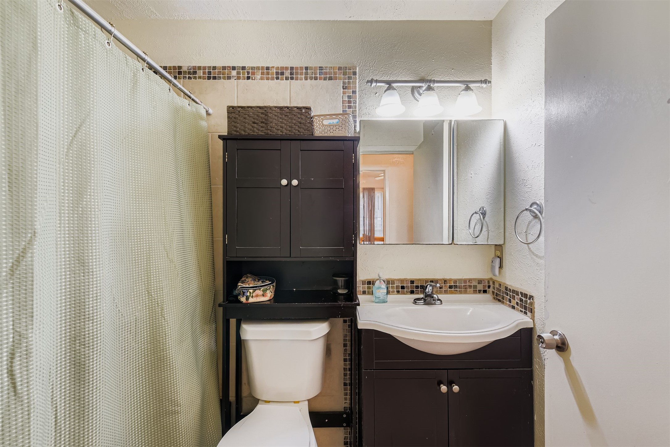3104 Dominic Drive Austin, TX 78745 - Photo 21 of 28 Bathroom featuring curtained shower, vanity, and a textured wall