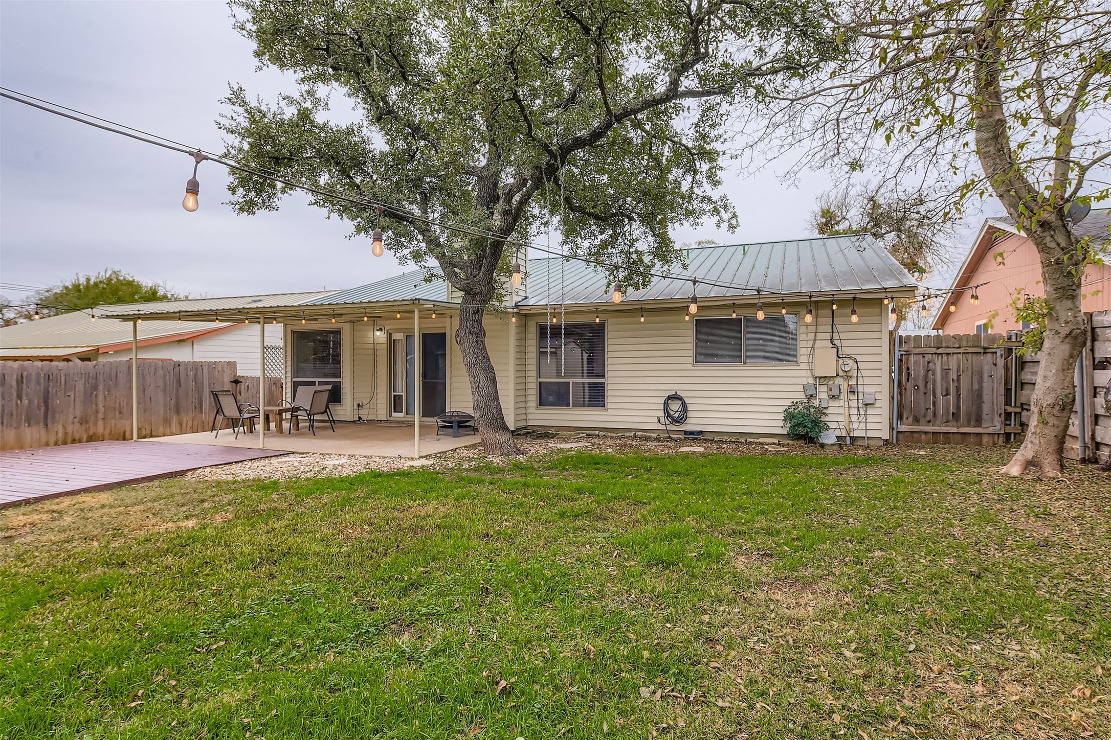3104 Dominic Drive Austin, TX 78745 - Photo 26 of 28 Back of property featuring a metal roof and a patio area