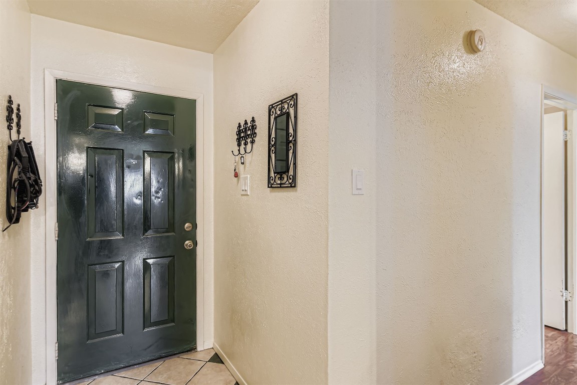 3104 Dominic Drive Austin, TX 78745 - Photo 5 of 28 Entrance foyer with tile patterned floors and a textured wall