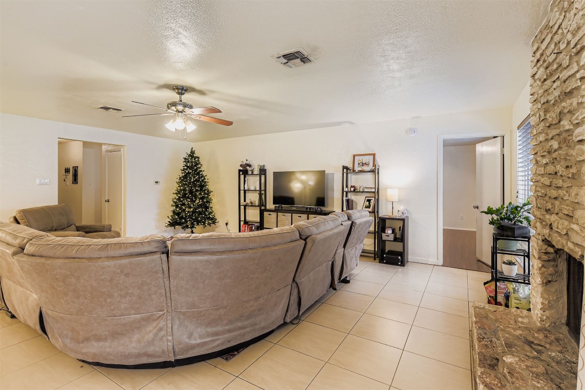 3104 Dominic Drive Austin, TX 78745 - Photo 7 of 28 Living area with a textured ceiling, ceiling fan, and light tile patterned flooring