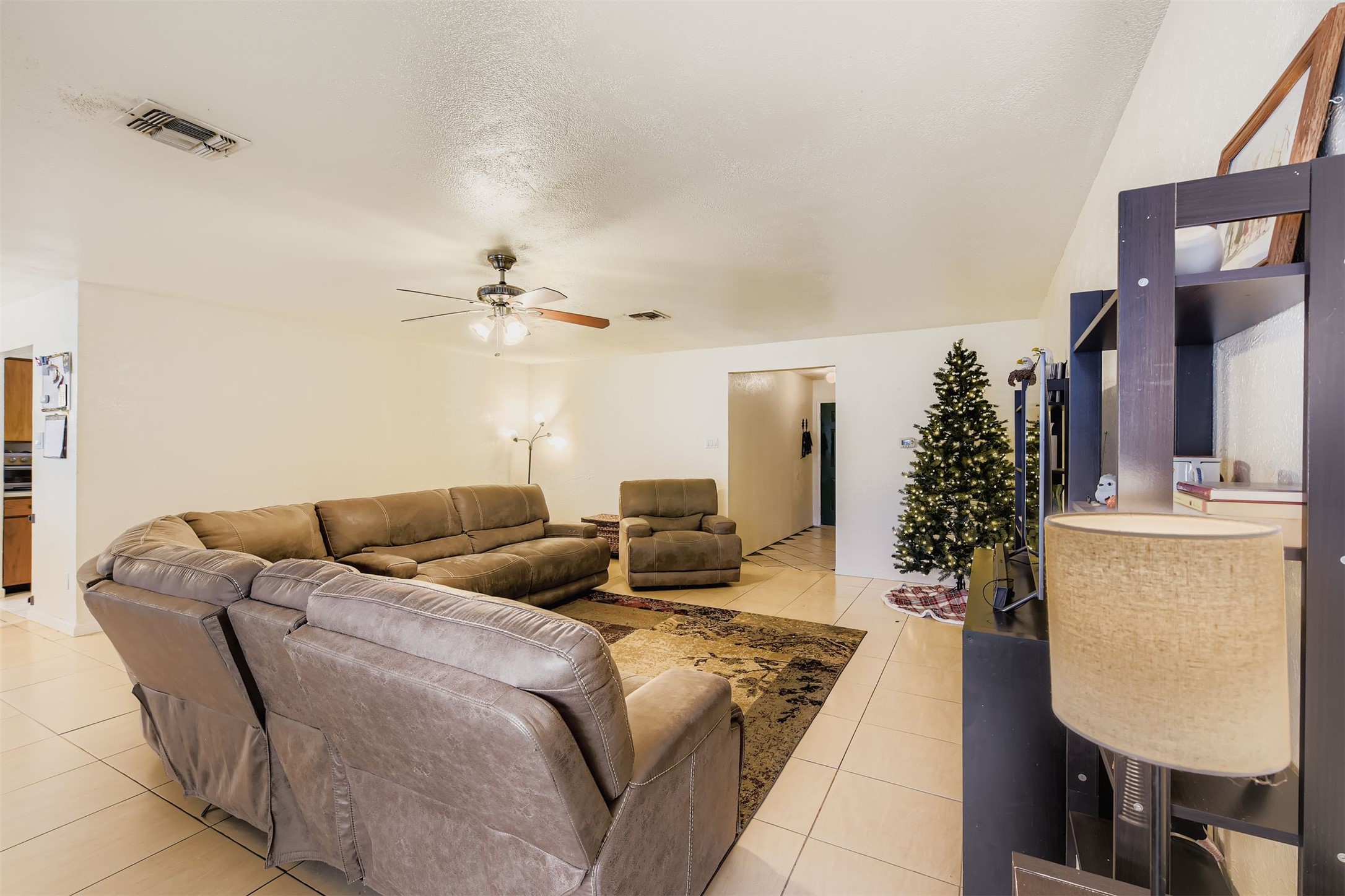 3104 Dominic Drive Austin, TX 78745 - Photo 8 of 28 Living room featuring light tile patterned floors, ceiling fan, and a textured ceiling