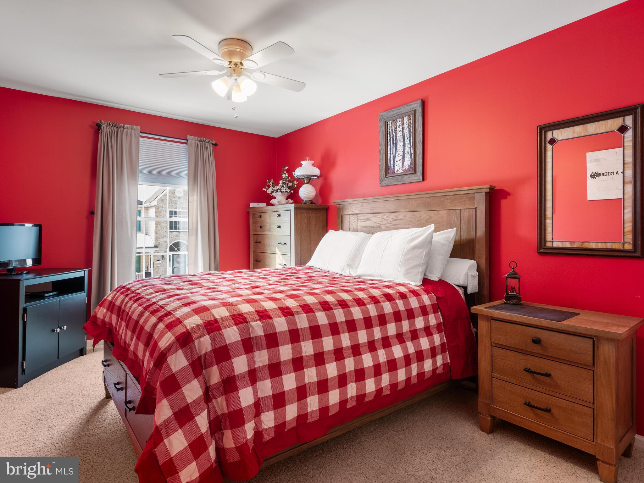 105 Hydrangea Way Coatesville, PA 19320 - Photo 17 of 26 a bedroom with a bed and a chandelier