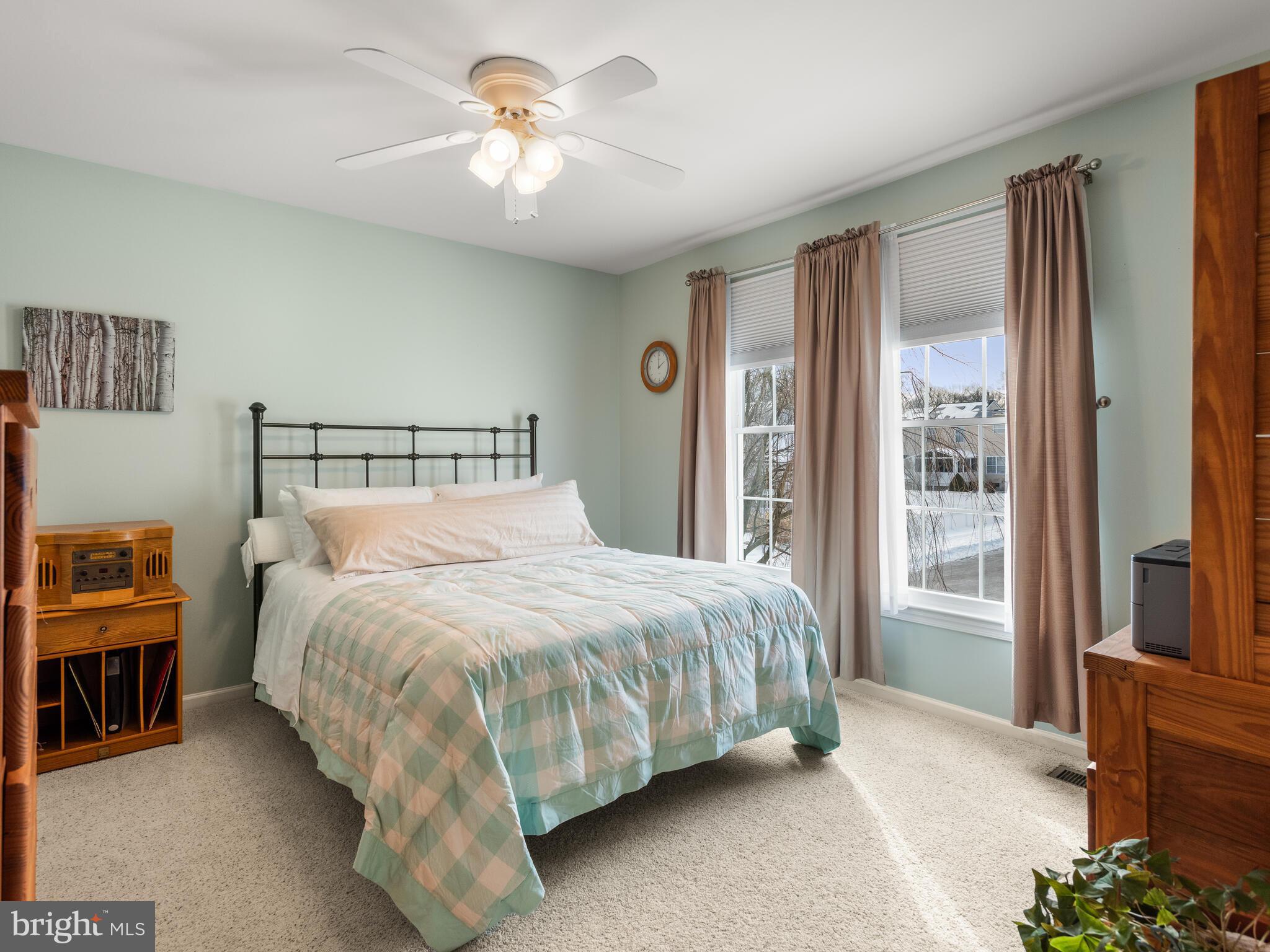 105 Hydrangea Way Coatesville, PA 19320 - Photo 19 of 26 a bedroom with a large bed and a chandelier