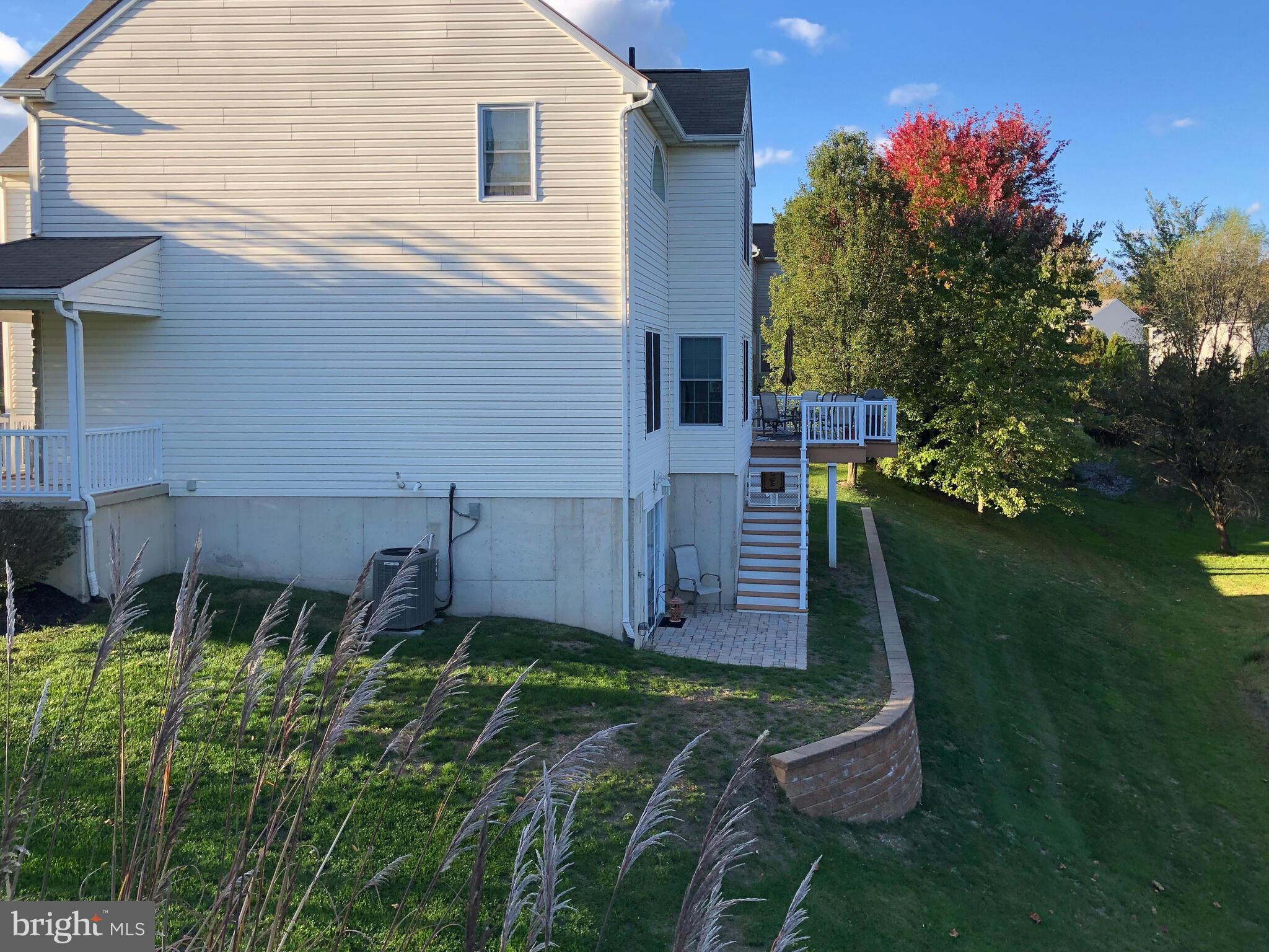 105 Hydrangea Way Coatesville, PA 19320 - Photo 24 of 26 a backyard of a house with table and chairs