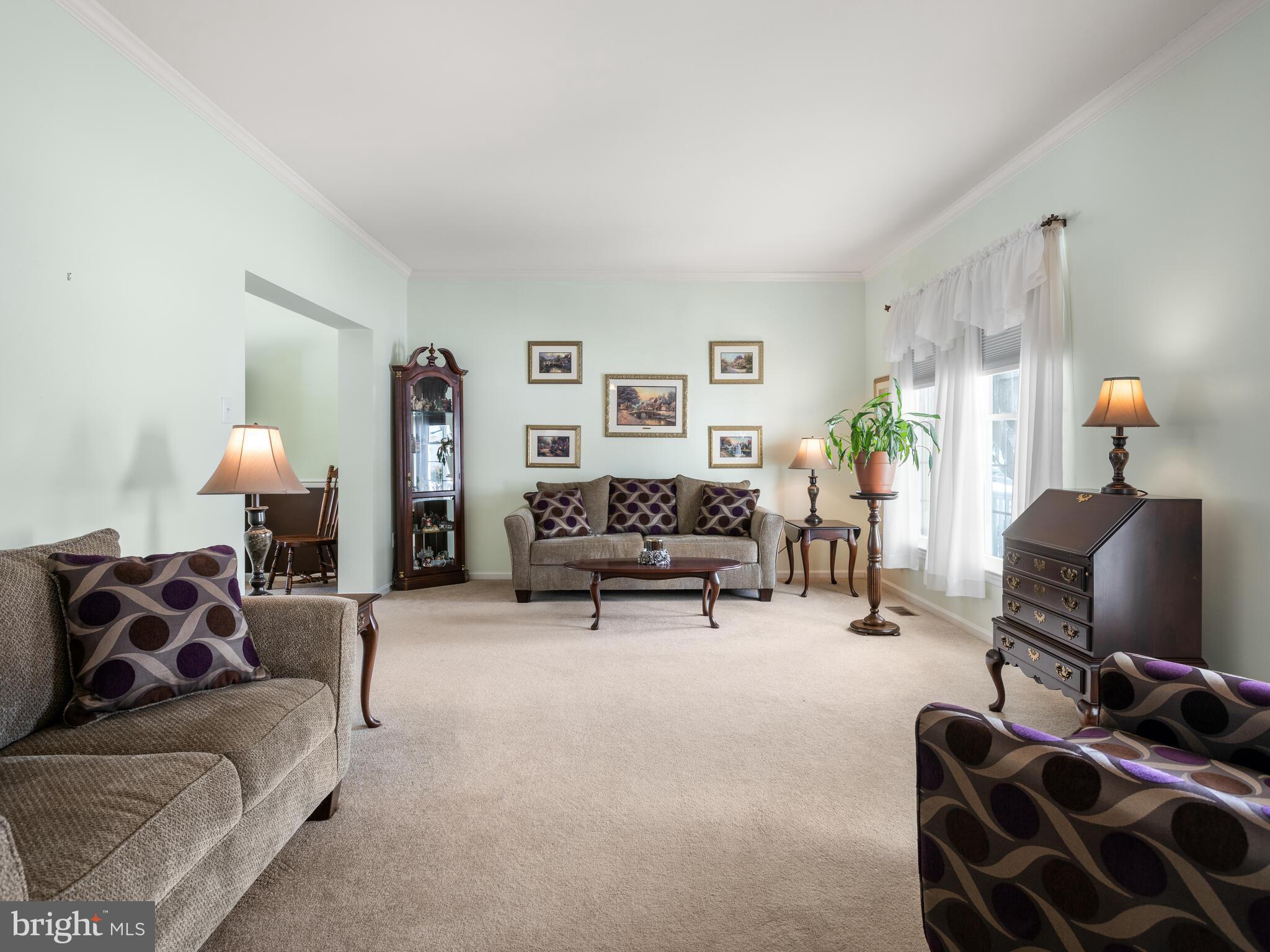 105 Hydrangea Way Coatesville, PA 19320 - Photo 4 of 26 a living room with furniture and a lamp