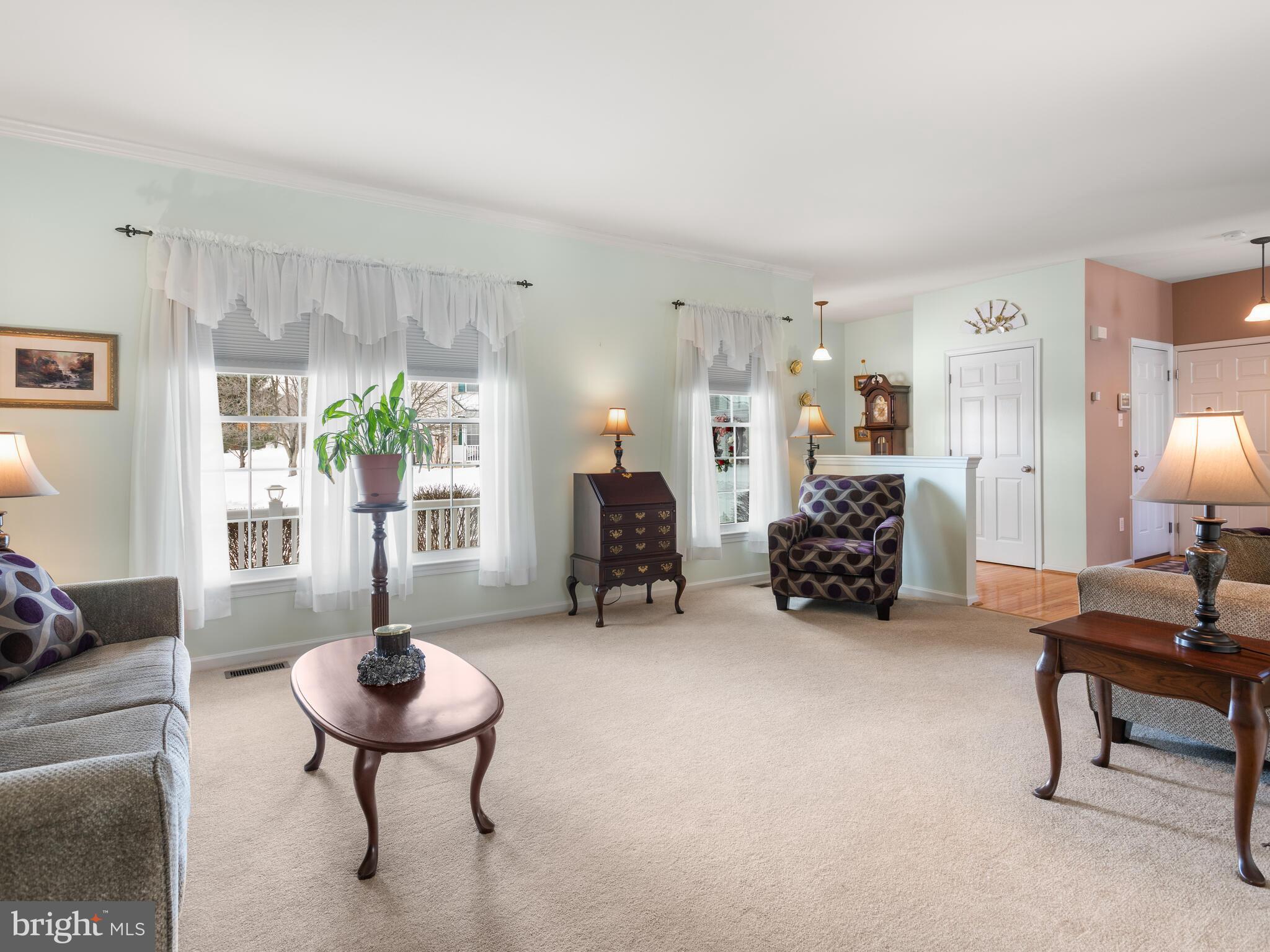 105 Hydrangea Way Coatesville, PA 19320 - Photo 5 of 26 a living room with furniture and a chandelier