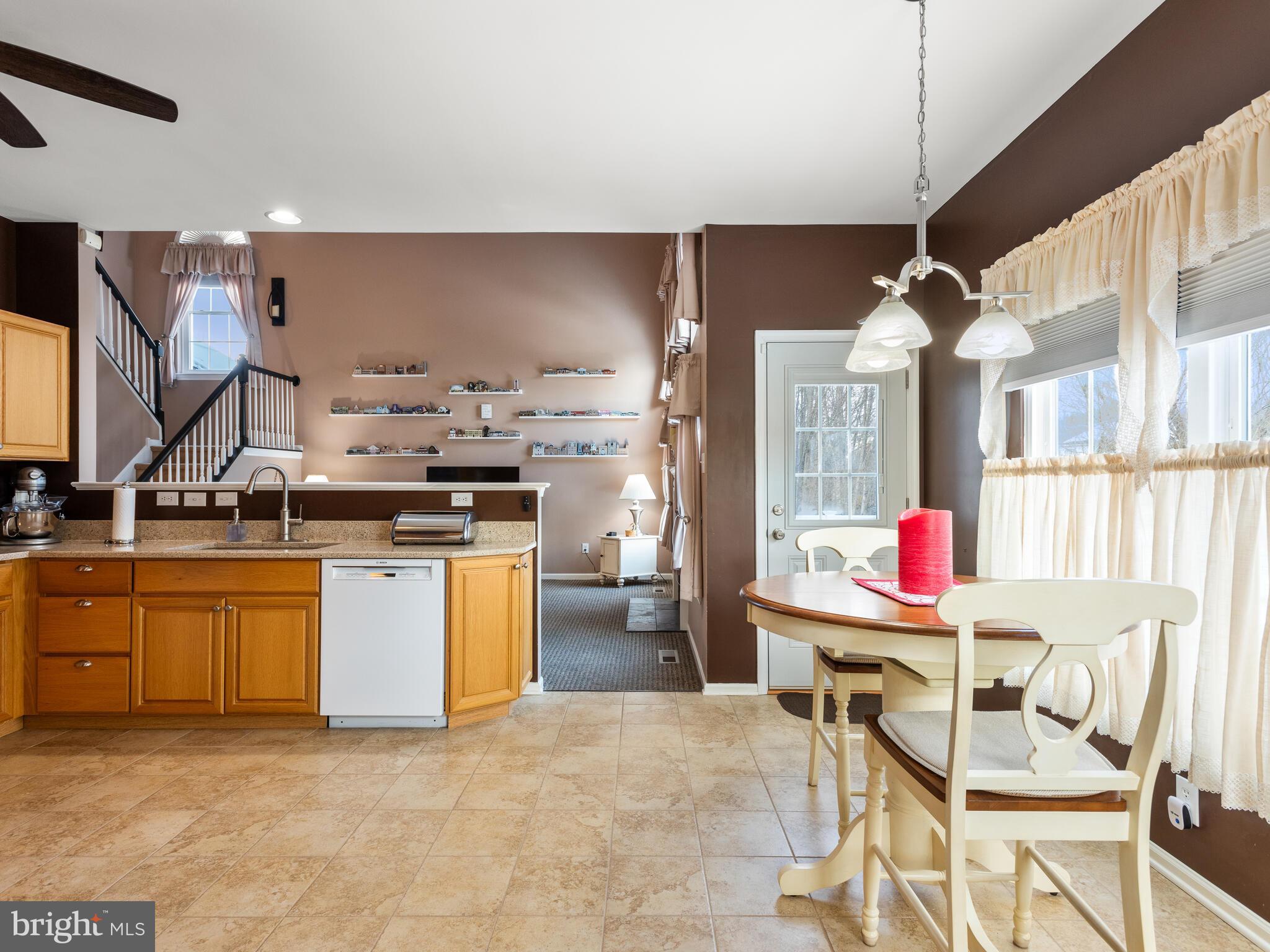 105 Hydrangea Way Coatesville, PA 19320 - Photo 10 of 26 a kitchen with stainless steel appliances kitchen island granite countertop a sink cabinets and stove top oven