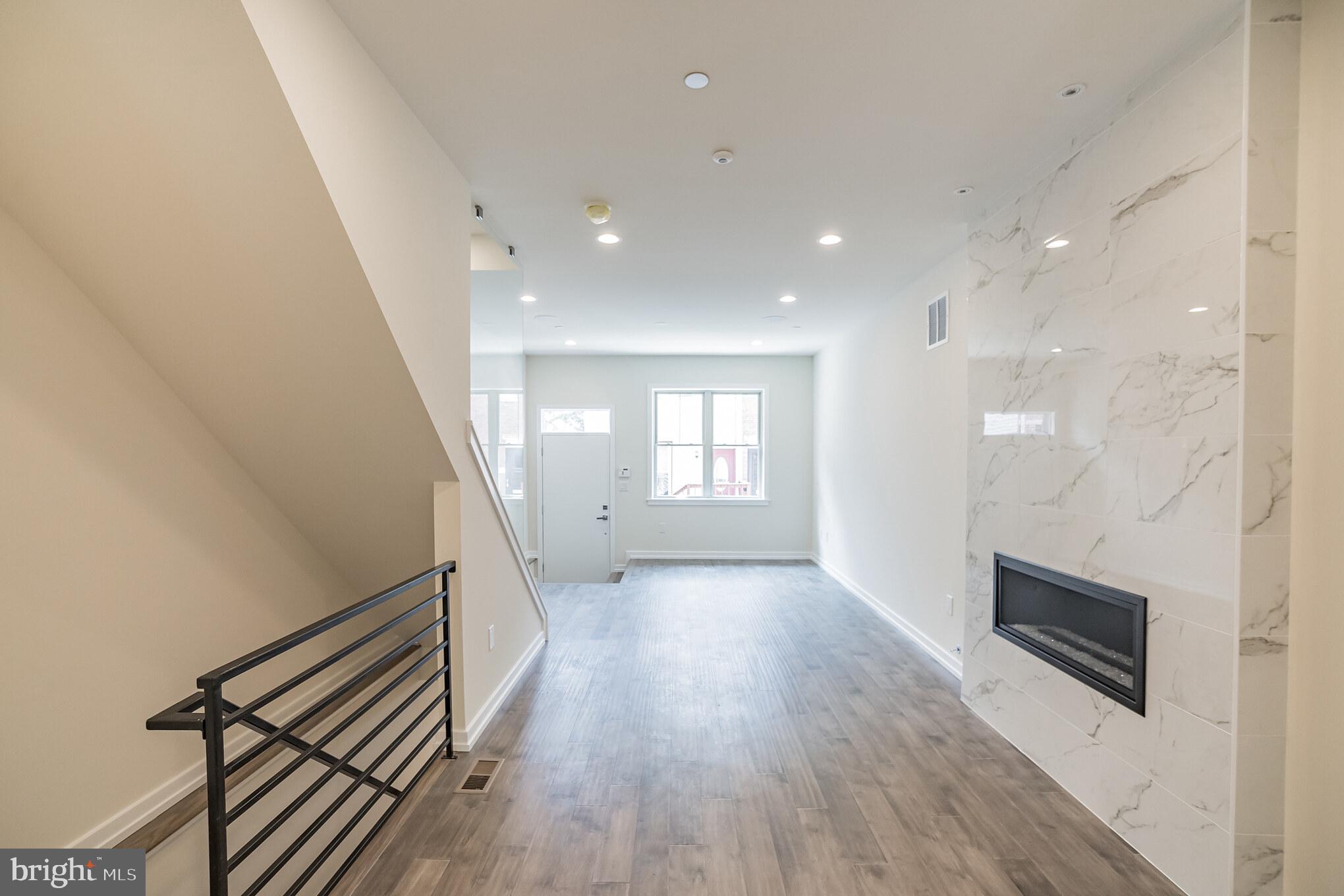 2133 Mifflin Street Philadelphia, PA 19145 - Photo 4 of 6 a view of a hallway with wooden floor and staircase