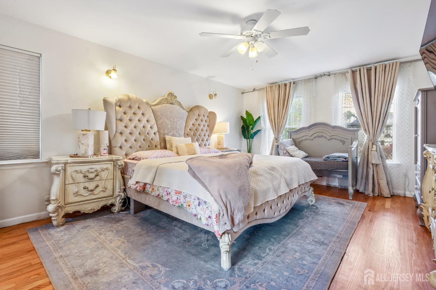 489 Plainfield Road Edison, NJ 08820 - Photo 22 of 39 a spacious bedroom with a bed a dresser and with window