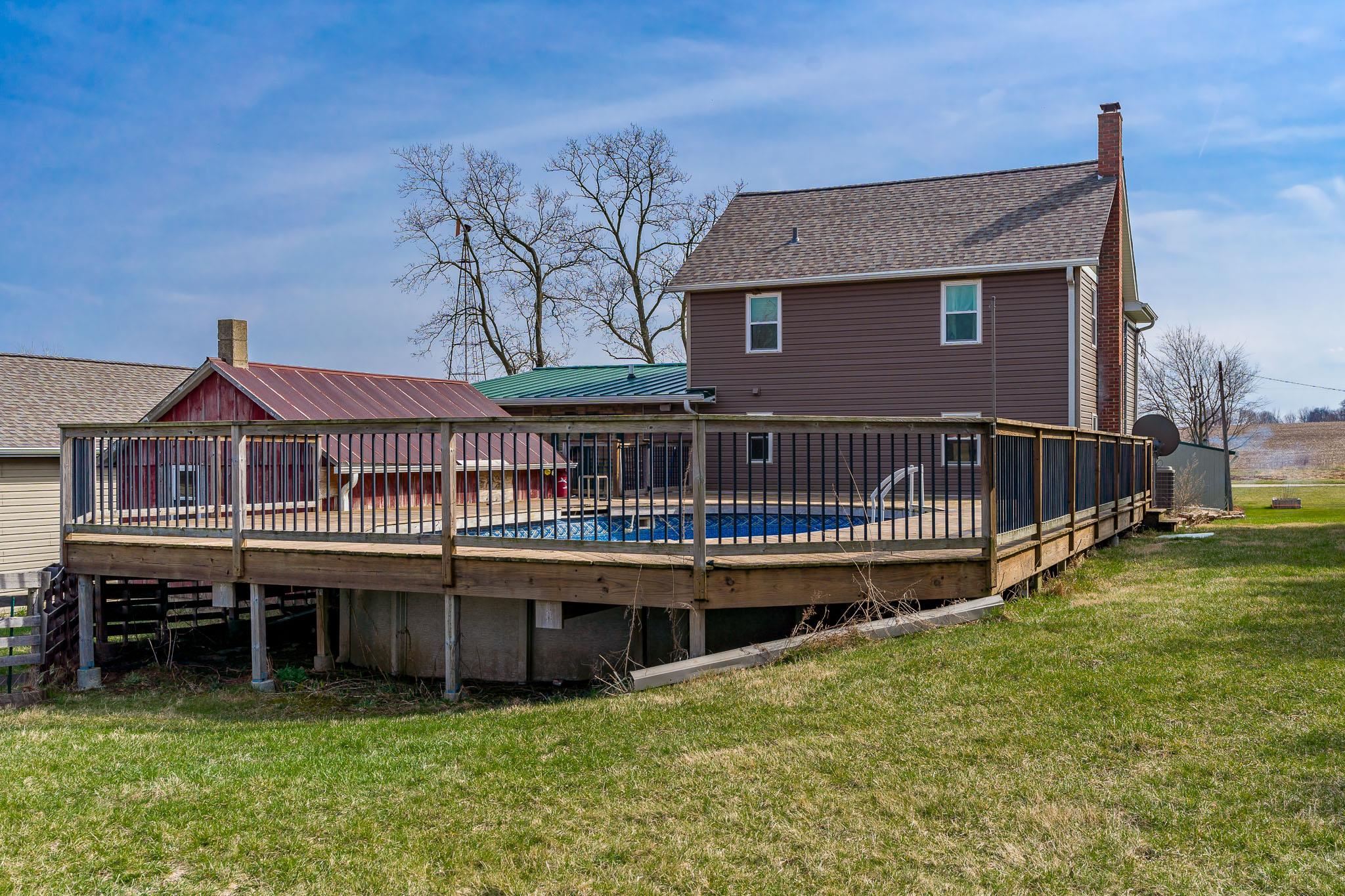 10760 East Rock Grove Road Davis, IL 61019 - Photo 27 of 91 a view of a house with a wooden deck and a yard