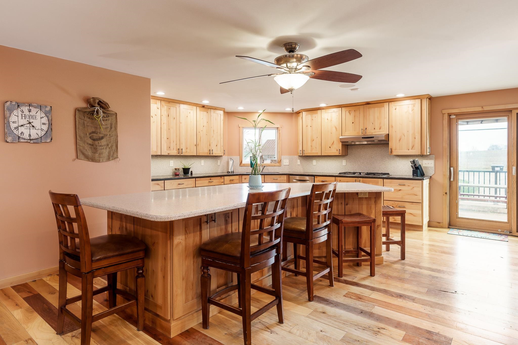 10760 East Rock Grove Road Davis, IL 61019 - Photo 62 of 91 a dining hall with stainless steel appliances granite countertop a dining table and chairs with wooden floor