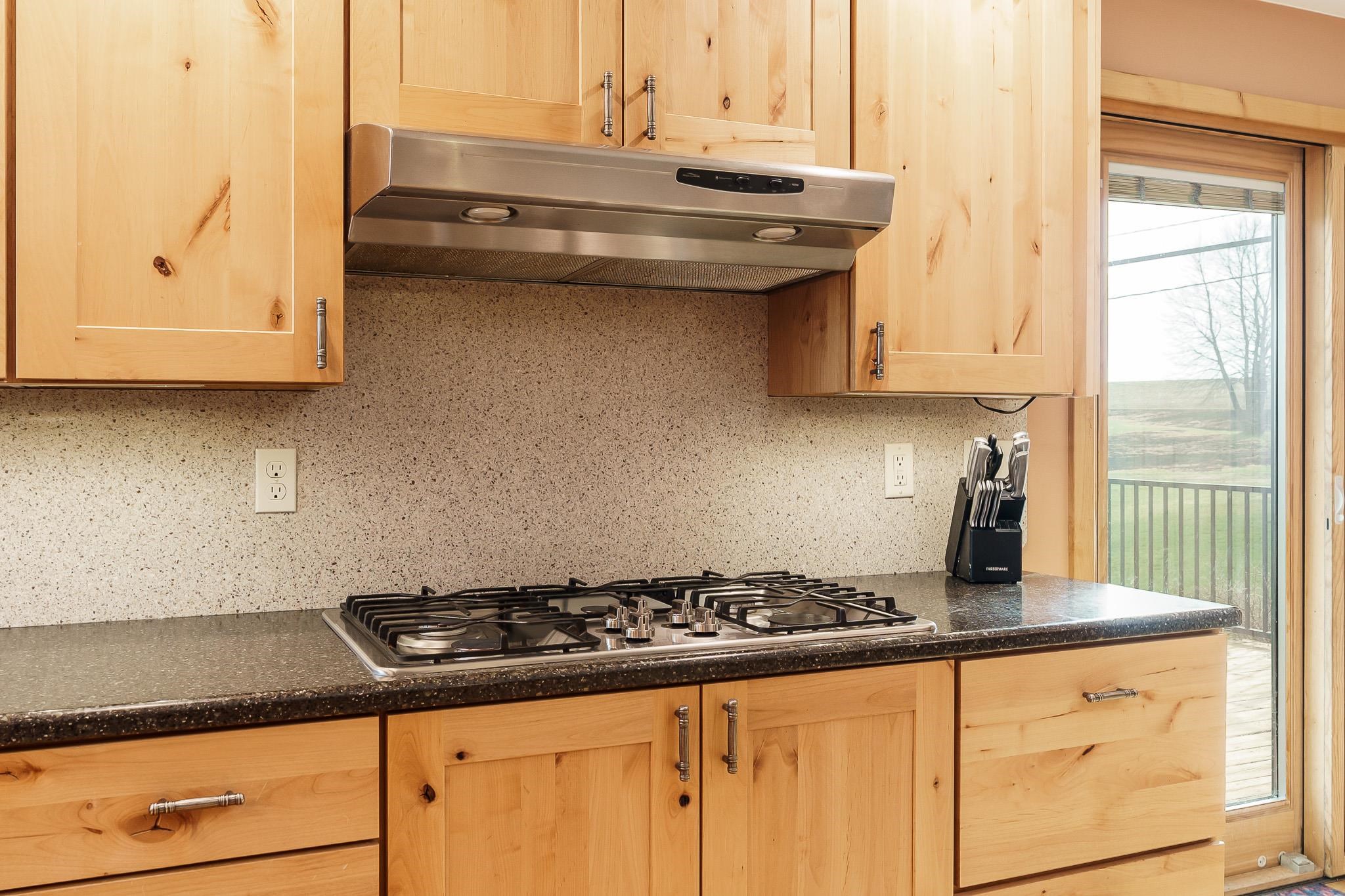 10760 East Rock Grove Road Davis, IL 61019 - Photo 65 of 91 a kitchen with granite countertop a sink a stove and cabinets