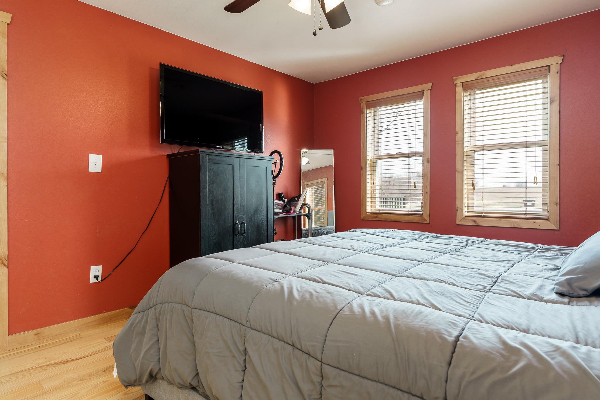 10760 East Rock Grove Road Davis, IL 61019 - Photo 73 of 91 a bedroom with a bed and a flat screen tv