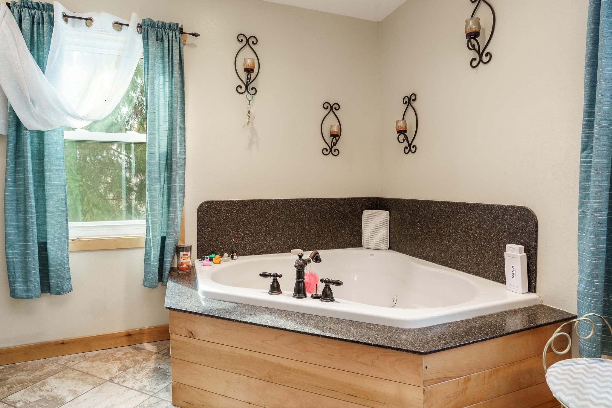 10760 East Rock Grove Road Davis, IL 61019 - Photo 84 of 91 a bathroom with a tub sink and mirror