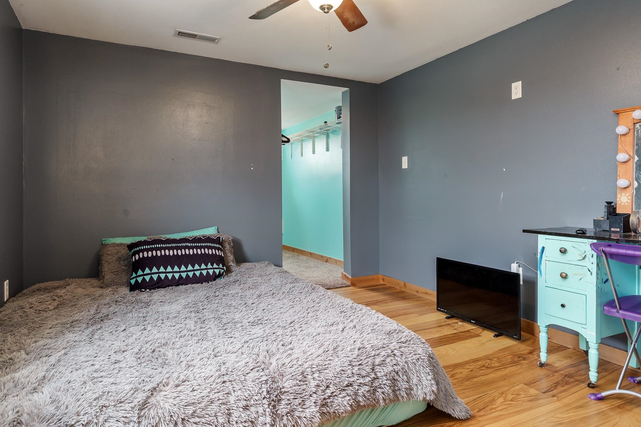 10760 East Rock Grove Road Davis, IL 61019 - Photo 86 of 91 a bedroom with a bed and a chandelier