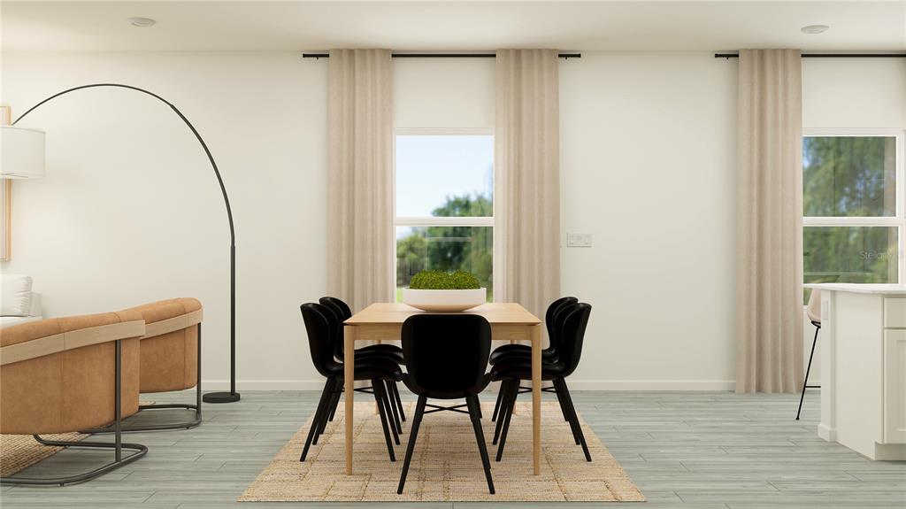 8675 Southwest 69th Terrace Ocala, FL 34476 - Photo 16 of 18 a view of a dining room with furniture and wooden floor