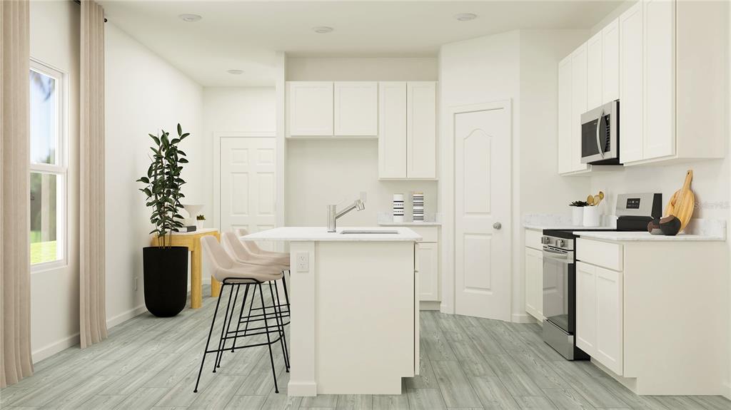 8675 Southwest 69th Terrace Ocala, FL 34476 - Photo 2 of 18 a kitchen with a refrigerator and a white cabinets