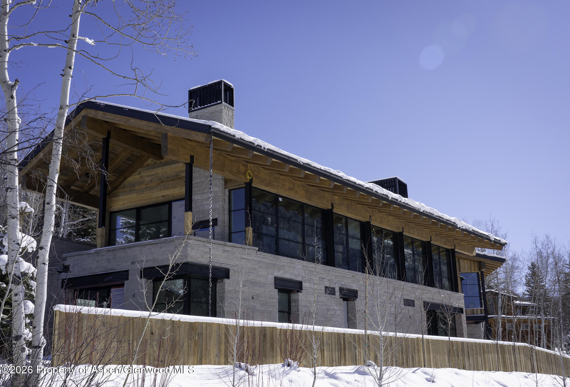 96 McSkimming Road Aspen, CO 81611 - Photo 5 of 16 a street view of a house with wooden fence