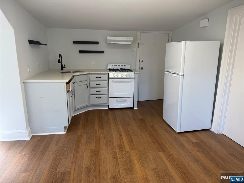 18 Lexington Avenue, Unit 3F Montclair, NJ 07042 - Photo 2 of 7 a kitchen with a refrigerator and a stove top oven