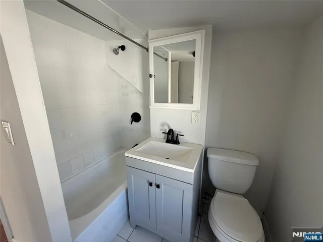 a white toilet sitting next to a bathroom sink