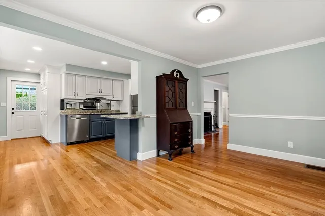 a kitchen with granite countertop a refrigerator and a stove top oven