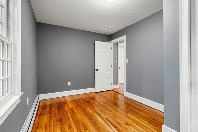 a view of room with wooden floor