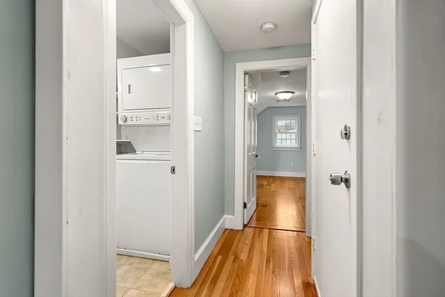 a bathroom with a walk in closet and wooden floor