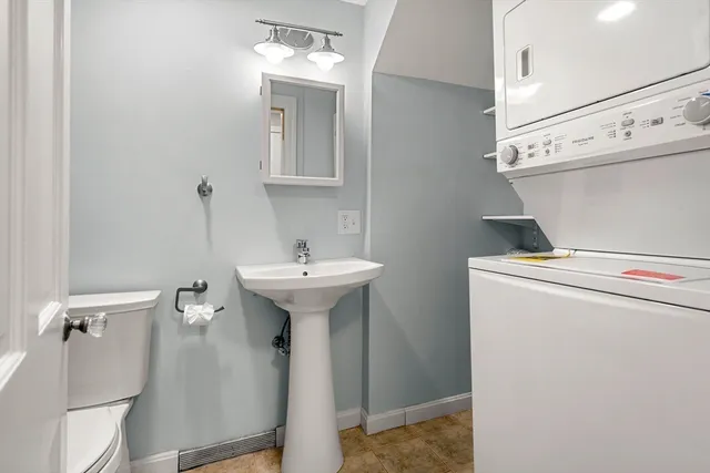 a bathroom with a sink toilet and mirror