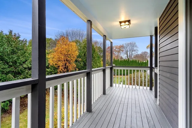 a view of a balcony with wooden floor and fence